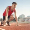 Track athlete ready to sprint, highlighting peak performance preparation