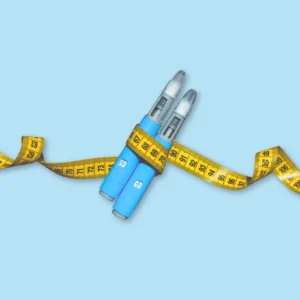 Weight loss injection pens with measuring tape representing medical weight loss treatment